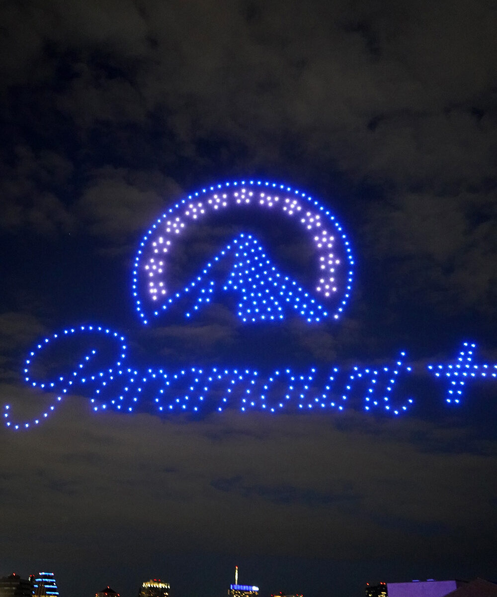 Drone light show forming a bright custom design in the night sky