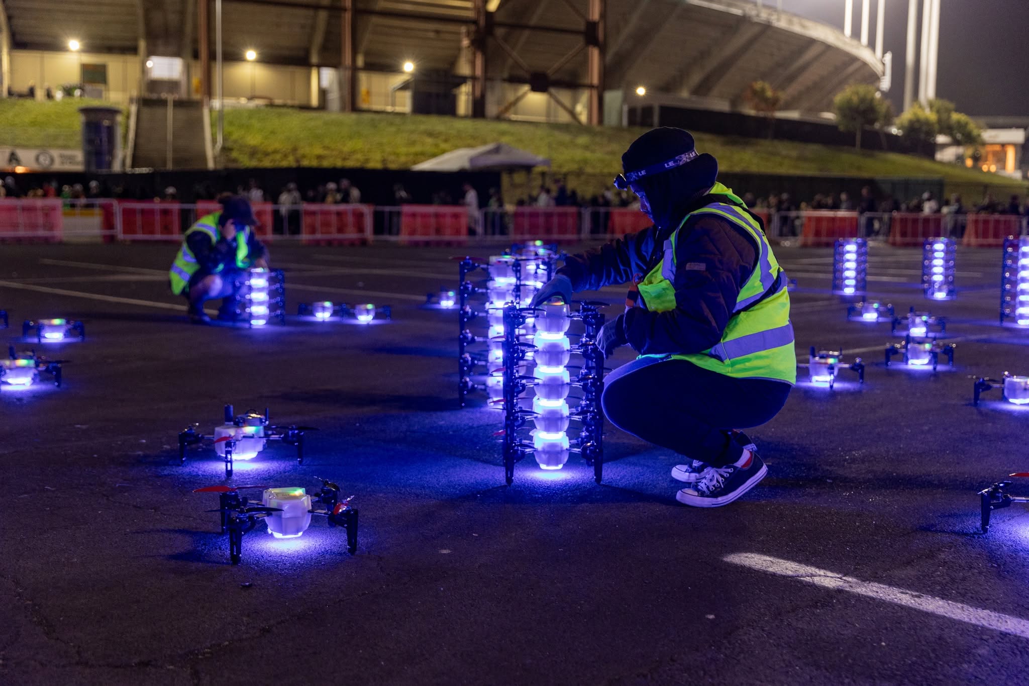 GeoDrones specialists preparing illuminated drones before a show